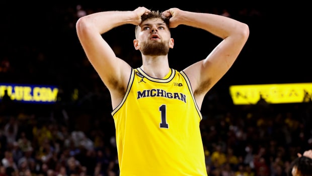 Hunter Dickinson puts both hands on his head in reaction